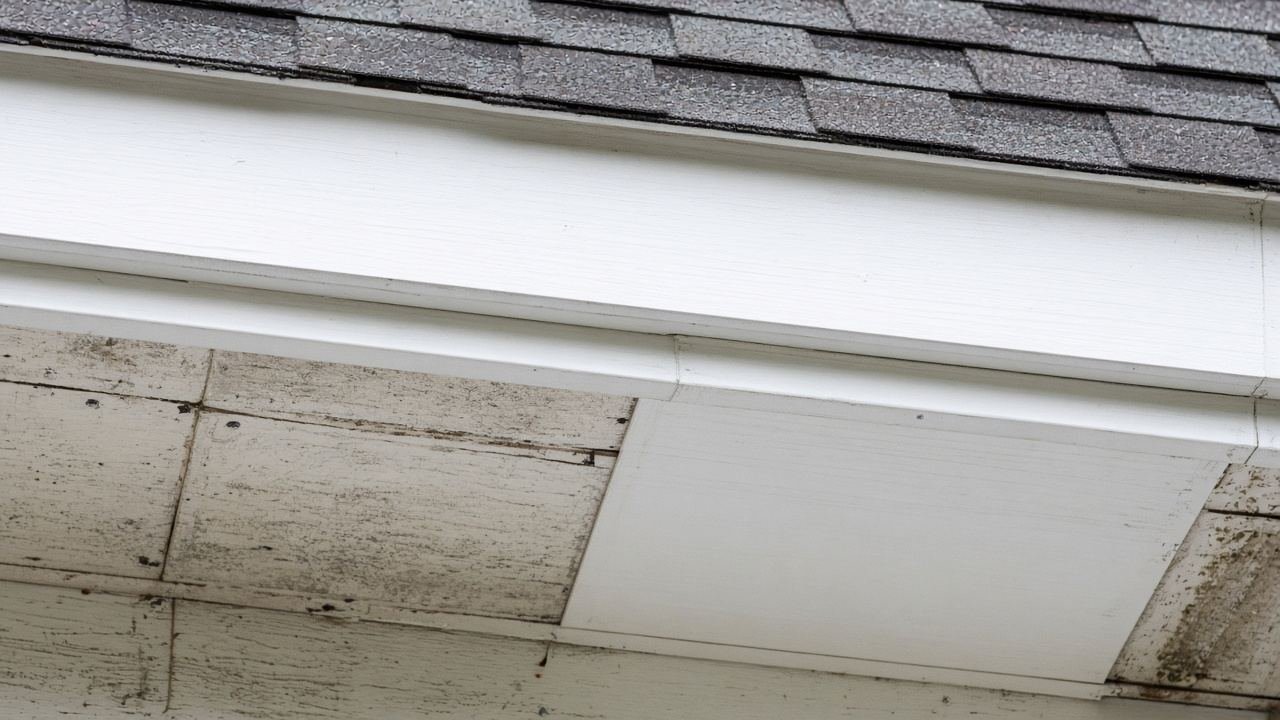 A new fascia board beside older weathered panels